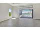 Living room features gray tile flooring and sliding doors leading to an outdoor patio with a pool at 552 Bocelli Dr, North Venice, FL 34275