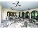 Covered outdoor patio with a bar, tables, and seating for entertaining at 552 Bocelli Dr, North Venice, FL 34275