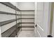 A walk-in pantry features wire shelving and ample storage space at 552 Bocelli Dr, North Venice, FL 34275