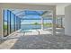 Screened patio features brick flooring, a pool, and a view of the lake at 552 Bocelli Dr, North Venice, FL 34275