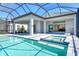 Outdoor pool and patio featuring jacuzzi, lanai, and seamless indoor/outdoor living at 552 Bocelli Dr, North Venice, FL 34275