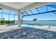 Beautiful pool with a lake view surrounded by brick pavers and screened in for enjoyment at 552 Bocelli Dr, North Venice, FL 34275