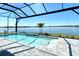 Beautiful screened in pool with lake view, surrounding landscaping and brick pavers at 552 Bocelli Dr, North Venice, FL 34275