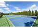 Scenic community tennis courts offering a great space for recreation, surrounded by green landscaping and blue skies at 552 Bocelli Dr, North Venice, FL 34275