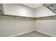 A neutral walk-in closet features wire racks and plush carpet at 552 Bocelli Dr, North Venice, FL 34275