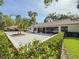 A well-kept backyard patio is framed by lush greenery and palm trees, creating a tranquil outdoor space at 5708 Garden Lakes Fern, Bradenton, FL 34203
