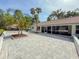 Lush palms adorn a backyard with a spacious patio, perfect for outdoor enjoyment at 5708 Garden Lakes Fern, Bradenton, FL 34203