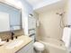 Bathroom with tile shower, updated vanity, and granite counter at 5708 Garden Lakes Fern, Bradenton, FL 34203