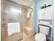 Bathroom featuring a tiled shower with a built-in seat and glass door at 5708 Garden Lakes Fern, Bradenton, FL 34203