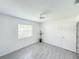 Bedroom with gray tile flooring, two windows and a ceiling fan at 5708 Garden Lakes Fern, Bradenton, FL 34203