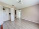 Bedroom with tile floors, ceiling fan, and a closet with bi-fold doors at 5708 Garden Lakes Fern, Bradenton, FL 34203