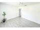 Bright bedroom featuring gray tile flooring and ample natural light at 5708 Garden Lakes Fern, Bradenton, FL 34203