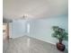 Spacious bedroom with light blue walls, ceiling fan, tile flooring, and ample natural light at 5708 Garden Lakes Fern, Bradenton, FL 34203