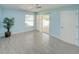 Bright bedroom featuring tile flooring, ceiling fan, natural light, closet, and sliding glass door at 5708 Garden Lakes Fern, Bradenton, FL 34203