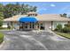 The community clubhouse has a stylish entrance and manicured landscaping, creating a welcoming gathering space at 5708 Garden Lakes Fern, Bradenton, FL 34203