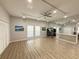 Large exercise room featuring mirrored walls, ceiling fans, a ping pong table, and light wood-look flooring at 5708 Garden Lakes Fern, Bradenton, FL 34203