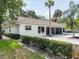 A well-maintained home exterior is complemented by manicured greenery and mature palm trees at 5708 Garden Lakes Fern, Bradenton, FL 34203