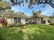 Charming single-story home with a well-manicured lawn, mature landscaping, and a tile roof at 5708 Garden Lakes Fern, Bradenton, FL 34203
