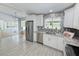 Bright kitchen featuring stainless steel appliances, granite countertops, and sliding doors to the outdoors at 5708 Garden Lakes Fern, Bradenton, FL 34203