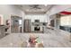 Modern kitchen boasts stainless steel appliances and a large island with quartz countertops at 5708 Garden Lakes Fern, Bradenton, FL 34203