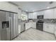 Renovated kitchen with white cabinets, stainless steel appliances, and decorative backsplash at 5708 Garden Lakes Fern, Bradenton, FL 34203