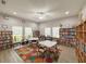 Bright community library room with bookshelves, tables, chairs, and a colorful area rug on the light wood-look flooring at 5708 Garden Lakes Fern, Bradenton, FL 34203