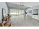 Bright living room featuring tile flooring, vaulted ceiling, chandelier lighting and bar at 5708 Garden Lakes Fern, Bradenton, FL 34203