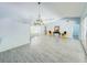 Bright living room featuring tile flooring, vaulted ceiling, and chandelier lighting at 5708 Garden Lakes Fern, Bradenton, FL 34203