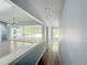 View of a hall with tile flooring and bright rooms off to the sides at 5708 Garden Lakes Fern, Bradenton, FL 34203