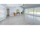 Bright living room featuring tile flooring, vaulted ceiling, and sliding glass doors leading to a screened-in lanai at 5708 Garden Lakes Fern, Bradenton, FL 34203