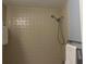 A shower with a handheld shower head and beige tiled walls at 5708 Garden Lakes Fern, Bradenton, FL 34203