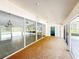 Bright sunroom with carpet, large sliding windows, and ceiling fans at 5708 Garden Lakes Fern, Bradenton, FL 34203
