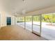 Inviting sunroom features carpeted flooring and sliding glass doors to a serene outdoor space at 5708 Garden Lakes Fern, Bradenton, FL 34203