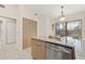 Bright kitchen boasts stainless steel appliances, granite counters, and an eat-in area with sliding glass doors at 5727 Monte Rosso Rd, Sarasota, FL 34243