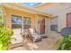 Enclosed patio with outdoor seating, potted plants, and BBQ grill at 5727 Monte Rosso Rd, Sarasota, FL 34243