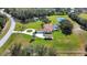 Sprawling estate features a large home, pool, pond, circular driveway, and lush landscaping at 5750 Saddle Oak Trl, Sarasota, FL 34241