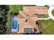 Aerial view of home with solar panels, screened pool, circular drive, and detached garage at 5750 Saddle Oak Trl, Sarasota, FL 34241