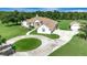 Aerial view of an estate with an in-ground pool, circular driveway, and mature trees at 5750 Saddle Oak Trl, Sarasota, FL 34241