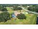 Aerial view of estate with screened pool, circular drive, and large lot at 5750 Saddle Oak Trl, Sarasota, FL 34241