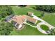 An aerial shot reveals a beautiful home with a pool, detached garage, and circular driveway at 5750 Saddle Oak Trl, Sarasota, FL 34241