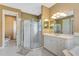 Bathroom with a glass shower enclosure, vanity with marble countertops, and neutral paint at 5750 Saddle Oak Trl, Sarasota, FL 34241