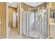 Elegant bathroom featuring a glass shower enclosure, neutral tile, and a separate vanity area at 5750 Saddle Oak Trl, Sarasota, FL 34241
