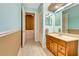 Bathroom featuring a vanity, sink, and storage, with a walk-in closet nearby at 5750 Saddle Oak Trl, Sarasota, FL 34241