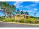 Saddle Oak Estates community sign with stone accents and mature landscaping at 5750 Saddle Oak Trl, Sarasota, FL 34241