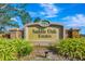 Saddle Oak Estates community sign with stone accents and attractive landscaping at 5750 Saddle Oak Trl, Sarasota, FL 34241