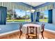 Bright dining area with a round table, elegant chairs, and expansive windows with pleasant view at 5750 Saddle Oak Trl, Sarasota, FL 34241