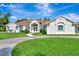 Charming white stucco home with a well-manicured lawn and inviting double-door entrance at 5750 Saddle Oak Trl, Sarasota, FL 34241