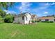 Exterior side view of the home with a well-maintained lawn and landscaping at 5750 Saddle Oak Trl, Sarasota, FL 34241