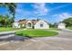 Beautiful one-story home with circular driveway, lush lawn, and attached garage at 5750 Saddle Oak Trl, Sarasota, FL 34241