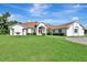 Charming single-story home boasts lush lawn, mature trees, and a welcoming entrance at 5750 Saddle Oak Trl, Sarasota, FL 34241